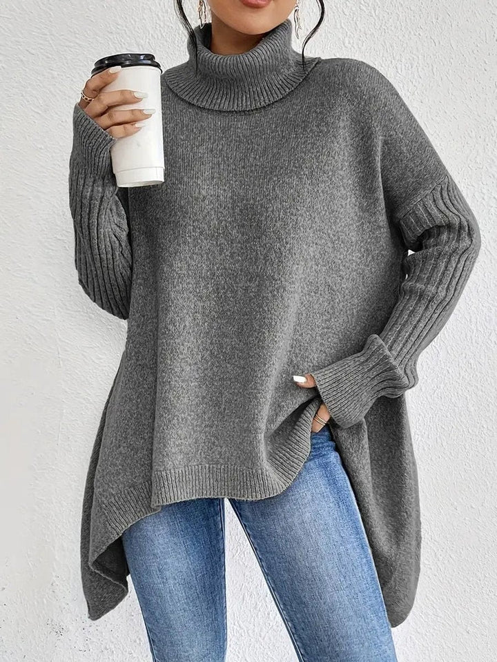 Charcoal grey ribbed turtleneck sweater styled with an asymmetric hemline