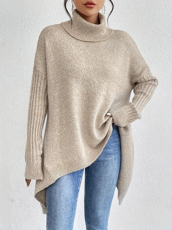 Beige ribbed turtleneck sweater showing dropped shoulders and flowing hem