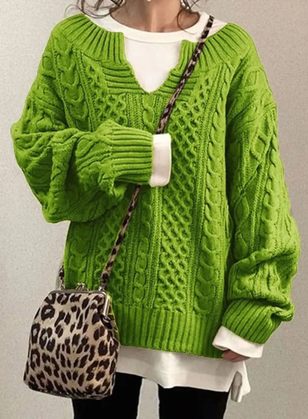 Lime green oversized cable knit sweater with V-neck and layered white top