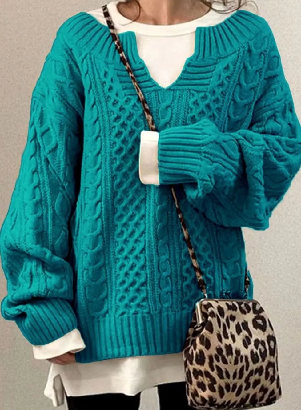 Teal cable knit jumper with chunky texture and layered white underlayer