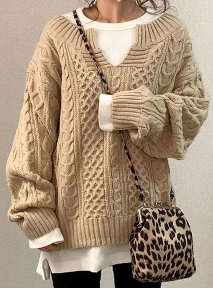 Beige cable knit sweater with oversized fit and layered white vest