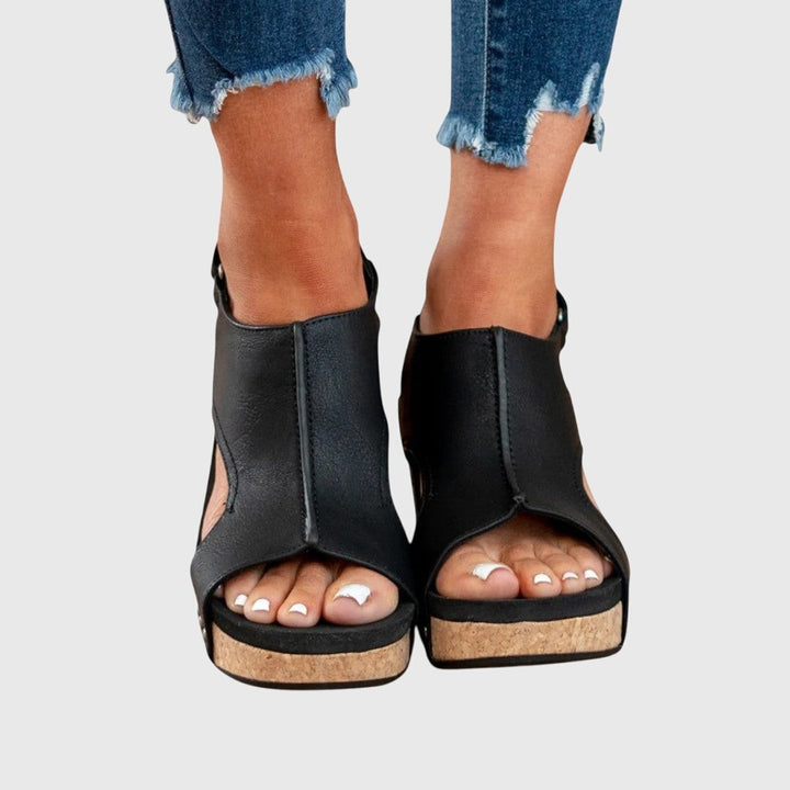 Black leather cut-out wedge sandals with cork platform sole