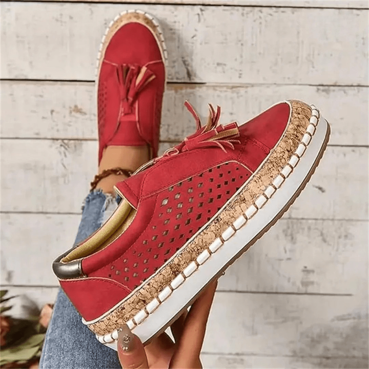 Single red suede loafer showing perforated panel and cork-trimmed platform sole