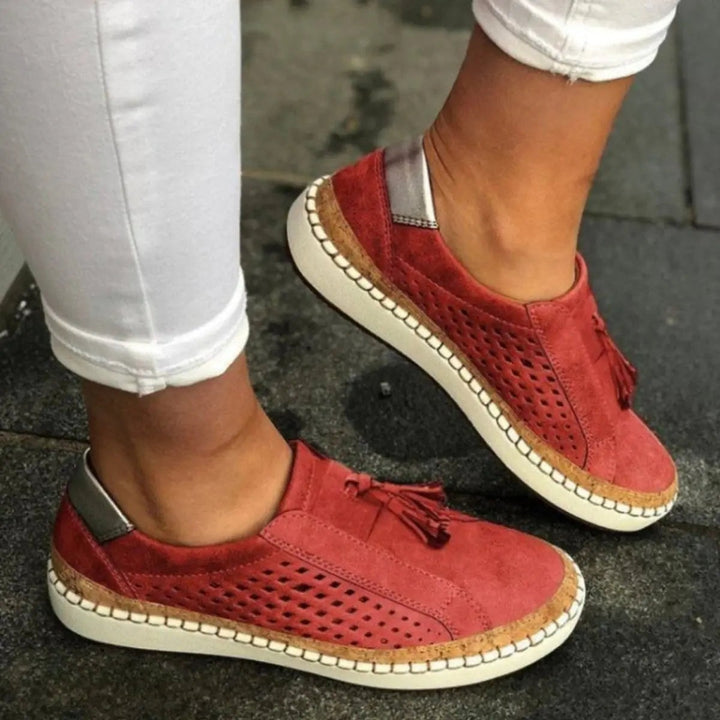 Rust red suede slip-on trainers featuring cork-effect sole and tassel trim
