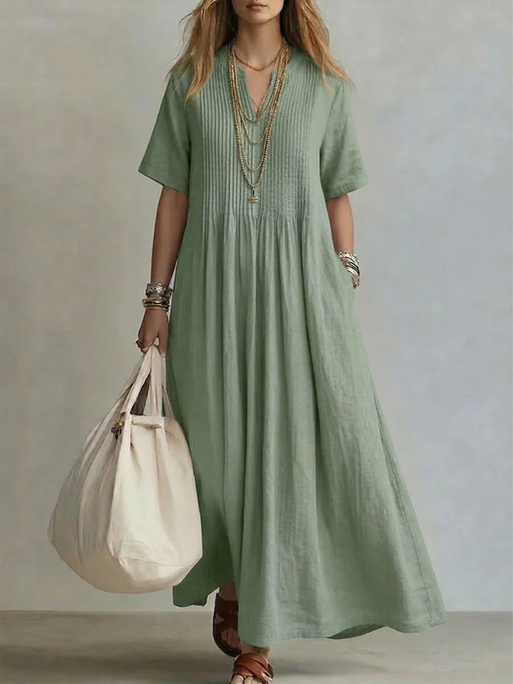 Sage green linen maxi dress featuring pleated V-neck bodice