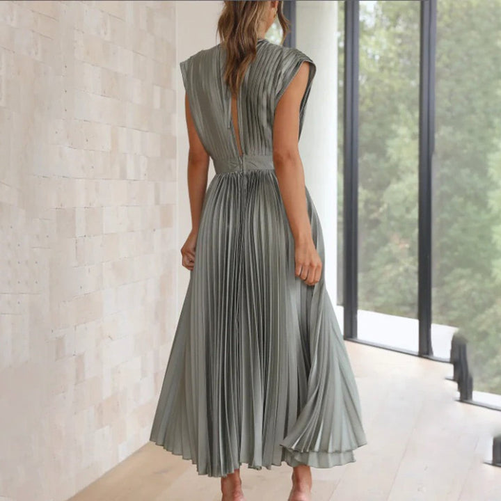 Sage green pleated dress rear view showing open-back tie detail