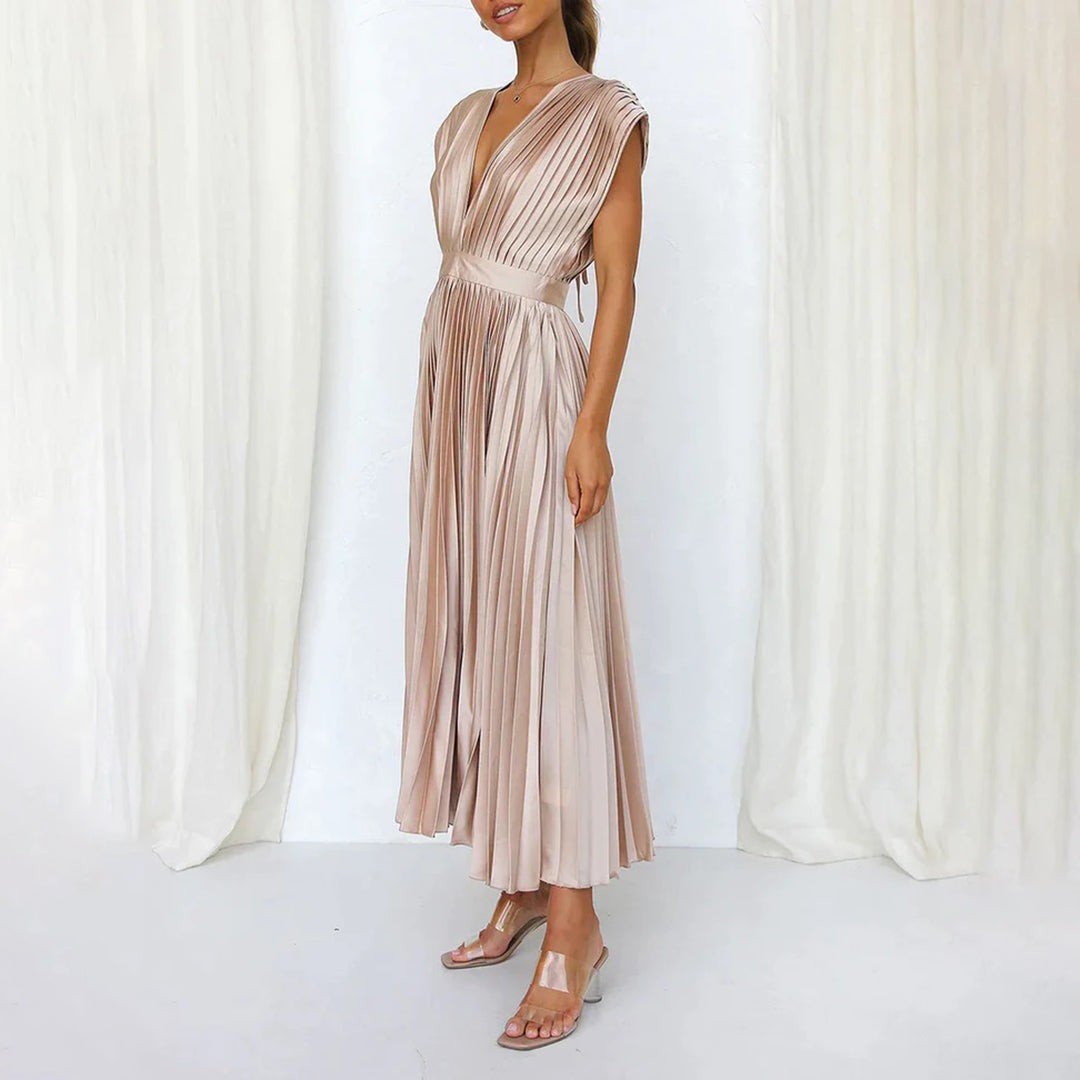 Champagne pleated satin dress with side slit, styled with clear heels