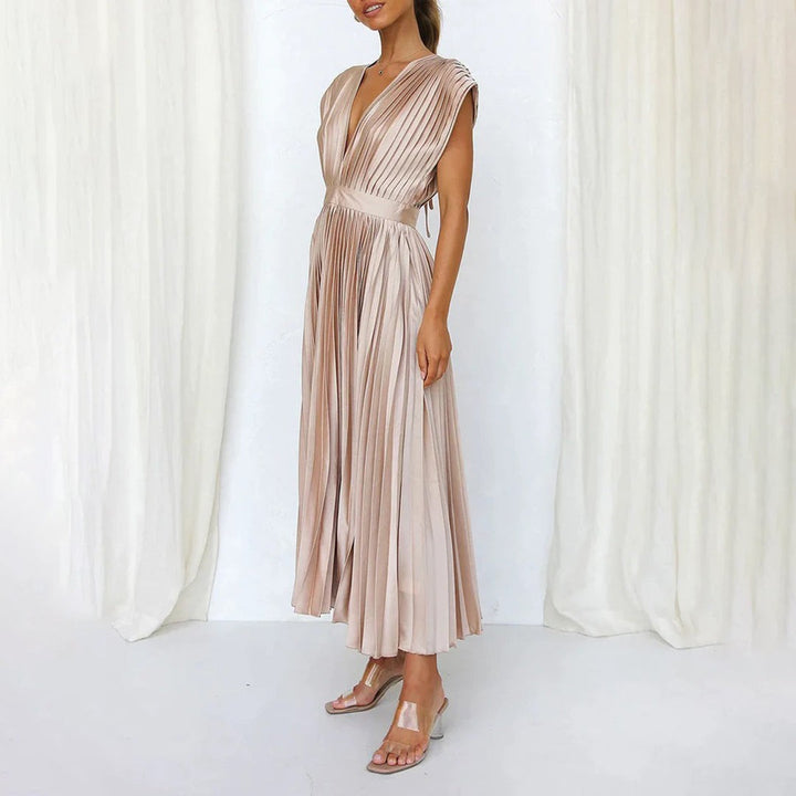 Champagne pleated satin dress with side slit, styled with clear heels