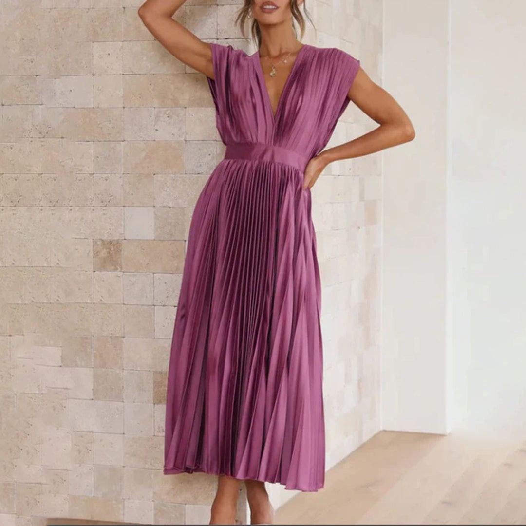 Champagne pleated dress rear view highlighting open back and tie straps