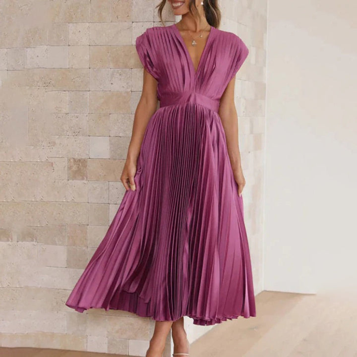 Magenta pleated satin midi dress with deep V-neckline, worn with heels