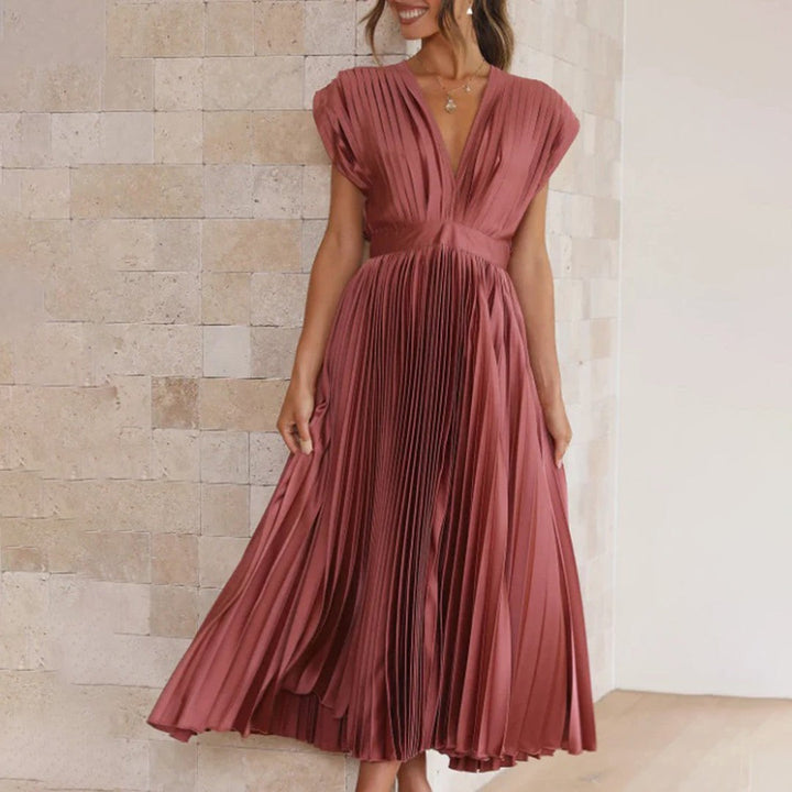 Rust pink pleated satin dress featuring cap sleeves and cinched waist