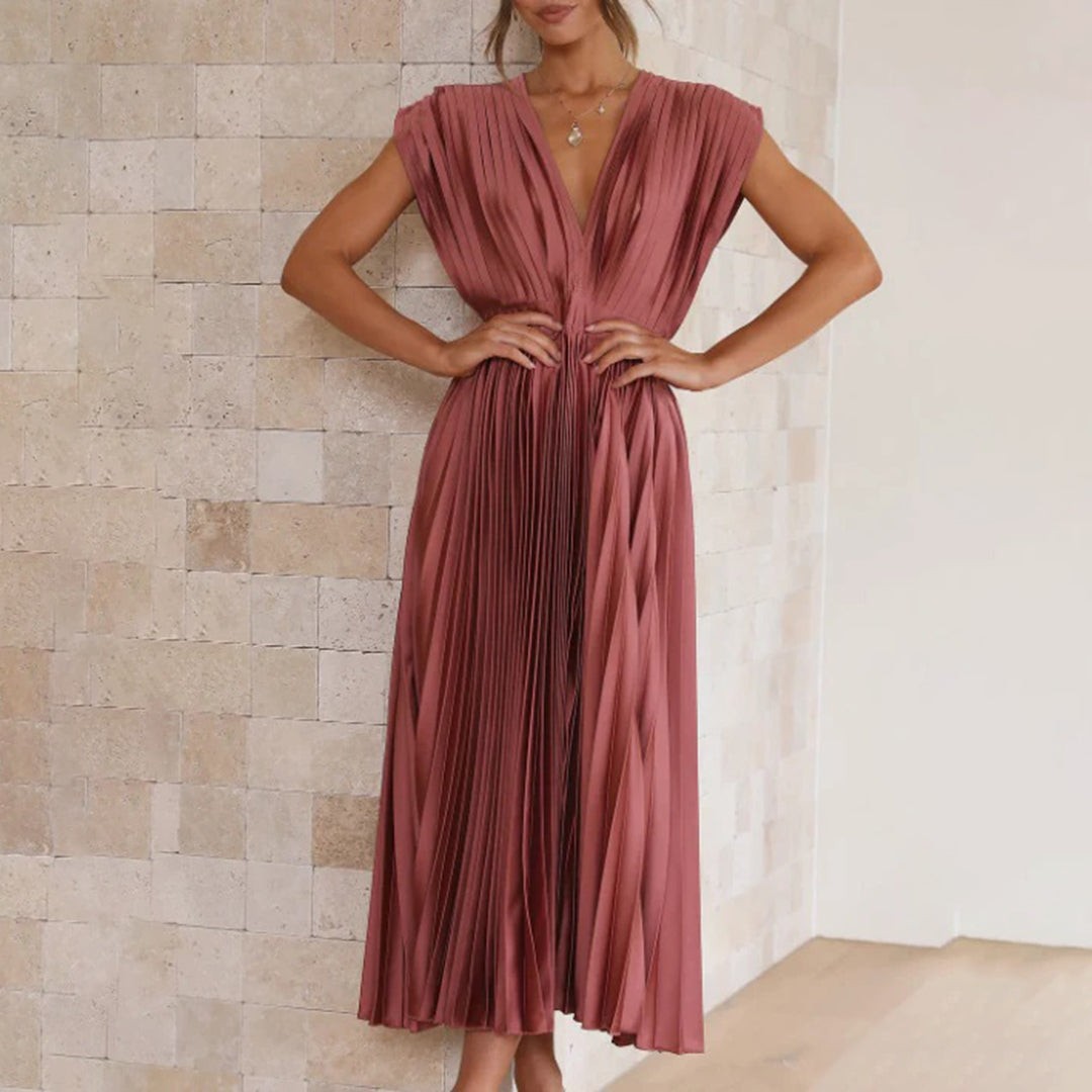 Terracotta pleated satin dress with cinched waist and cap sleeves