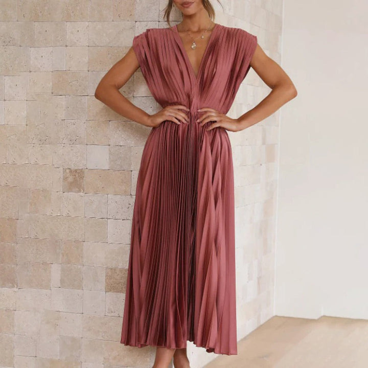 Terracotta pleated satin dress with cinched waist and cap sleeves
