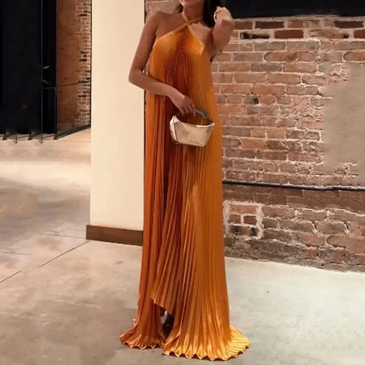 Rust-toned pleated evening dress featuring a crossover halter neckline and trailing hem