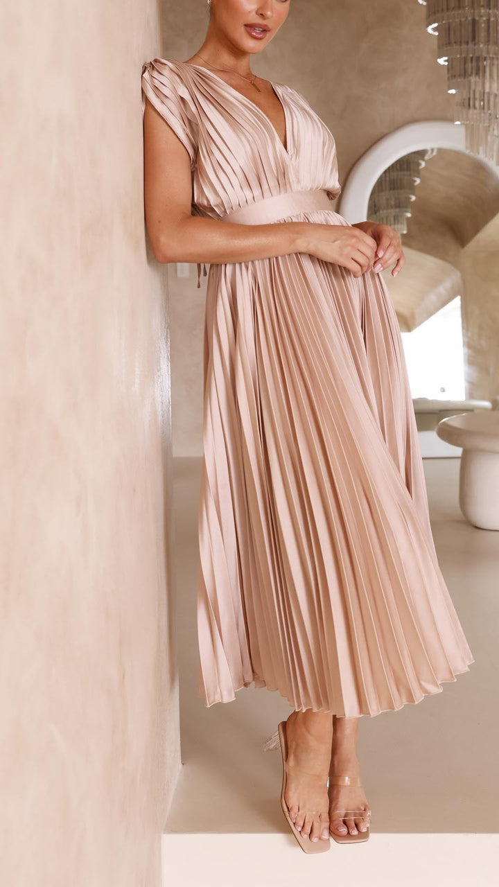 Rear view of blush pleated dress revealing tie-back open detail