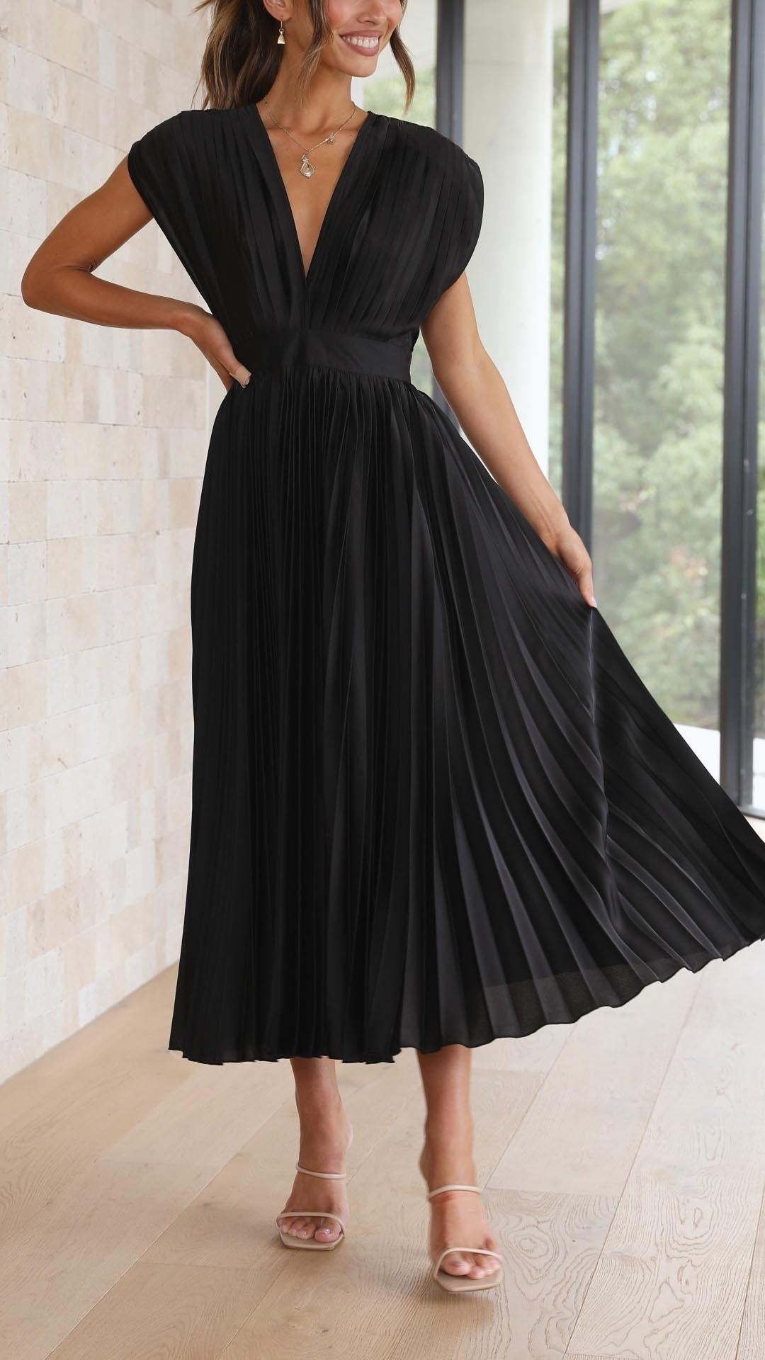 Black pleated satin dress with cinched waist and V-neck bodice