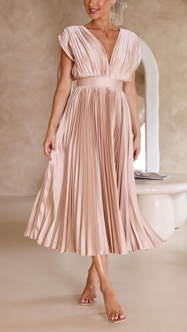 Blush pleated maxi dress showing elasticated waistband and flowing skirt