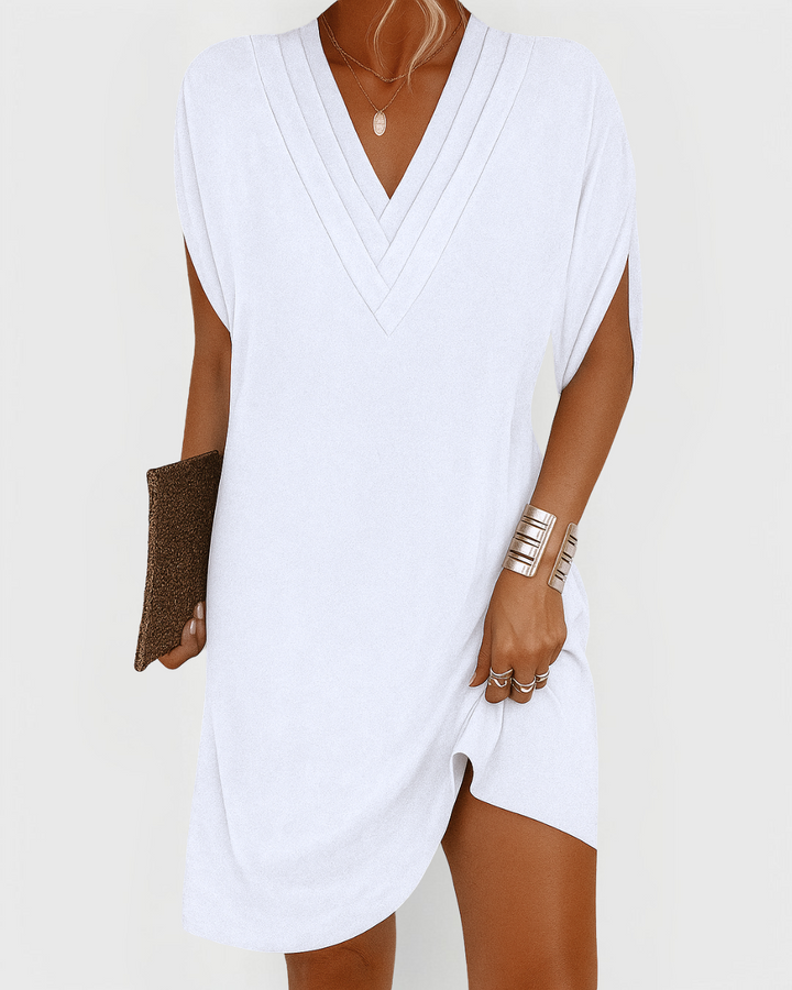 White V-neck mini dress with pleated trim and relaxed batwing sleeves