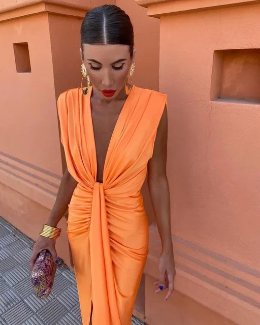Orange pleated maxi dress featuring deep V-neckline and ruched waist