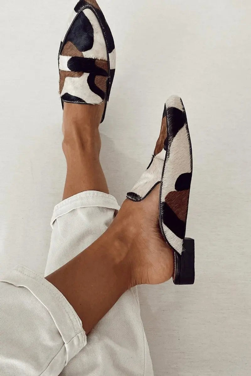 Cow print leather mule loafers showing block heel and pointed toe detail