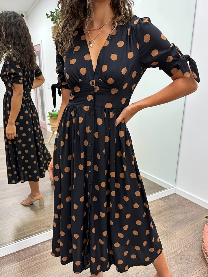 Black polka dot midi dress with plunging V-neck and tie-sleeve detail