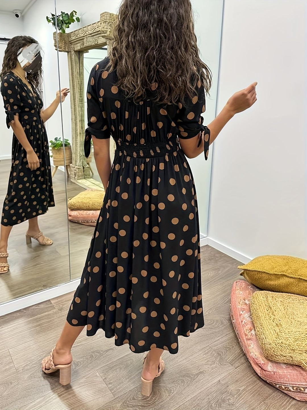 Rear view of black spotted midi dress showing shirred elasticated waistband