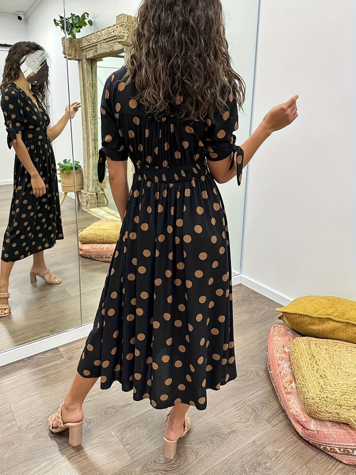 Rear view of black spotted midi dress showing shirred elasticated waistband