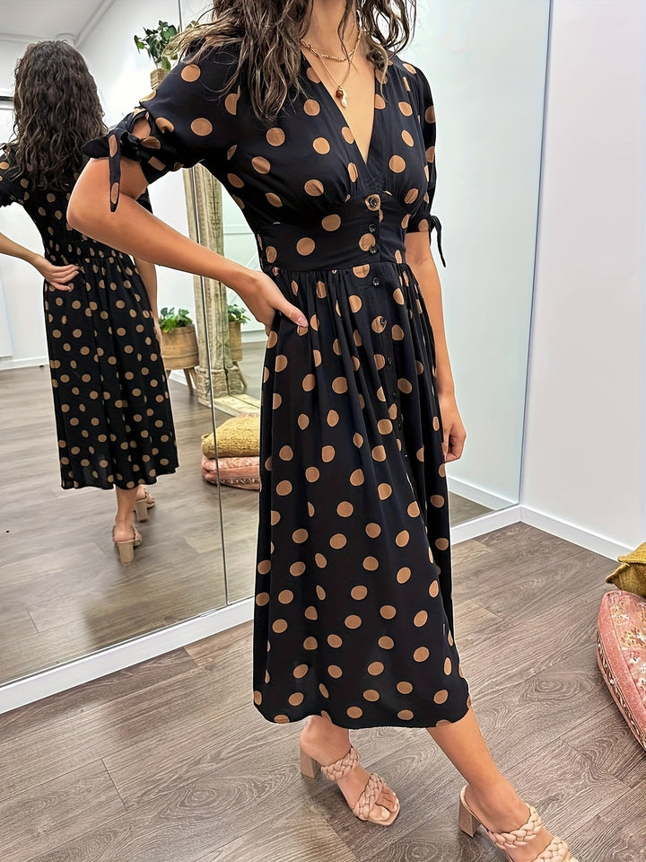 Side view of black and tan spotted dress with cut-out tied sleeve
