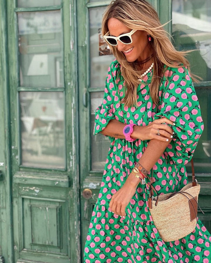 Rose print maxi dress with tiered hem and balloon sleeves, paired with woven crossbody bag