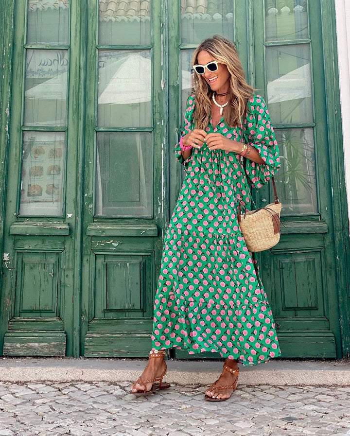 Green polka rose maxi dress with flowing tiered skirt, accessorised with studded sandals
