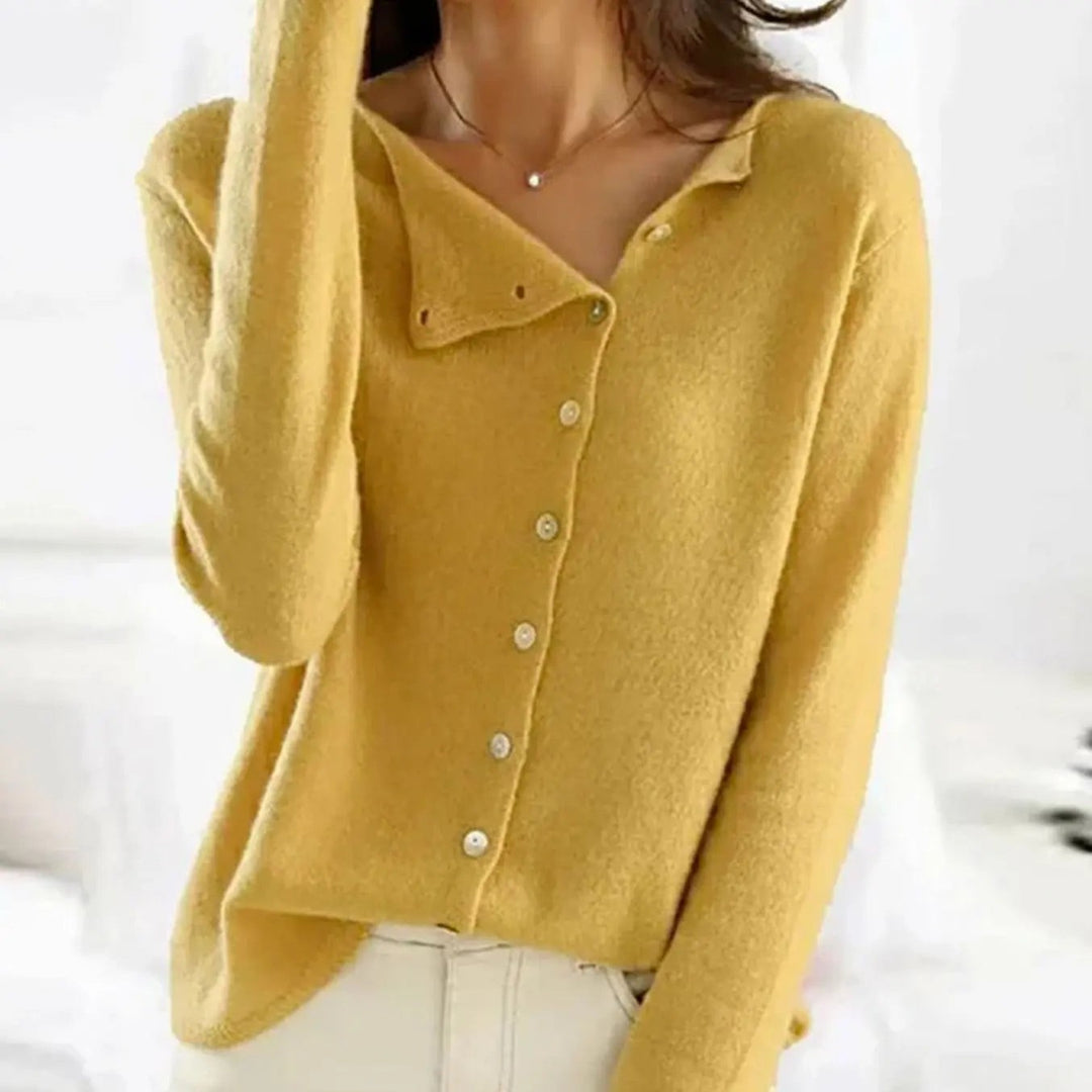 Mustard yellow button-front knit jumper worn with cream tailored trousers