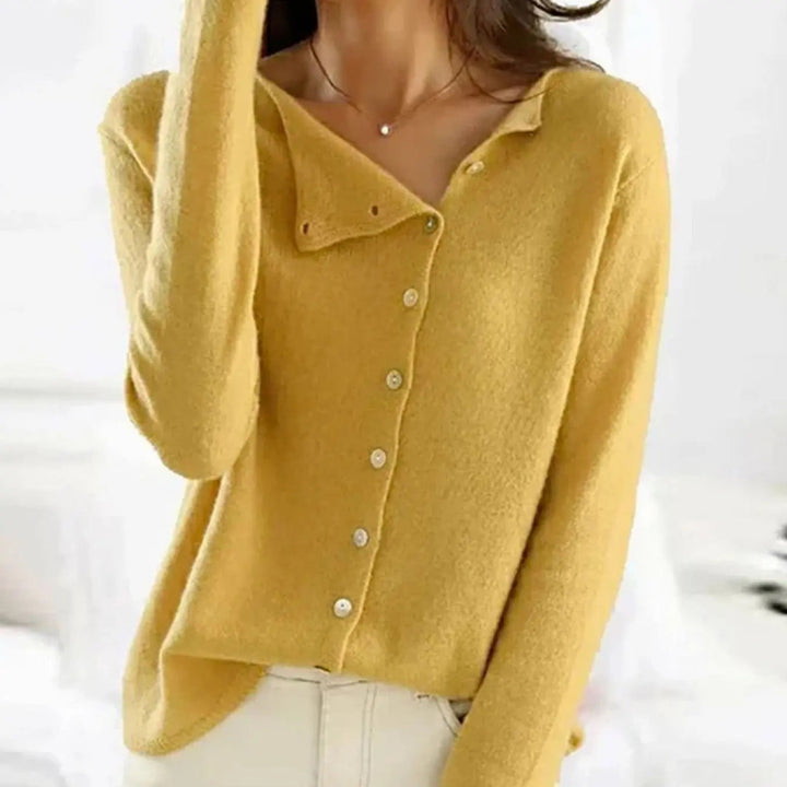 Mustard yellow button-front knit jumper worn with cream tailored trousers