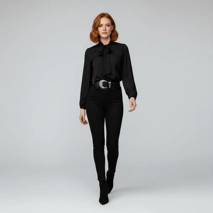 Black pussy-bow blouse styled with skinny jeans and ankle boots