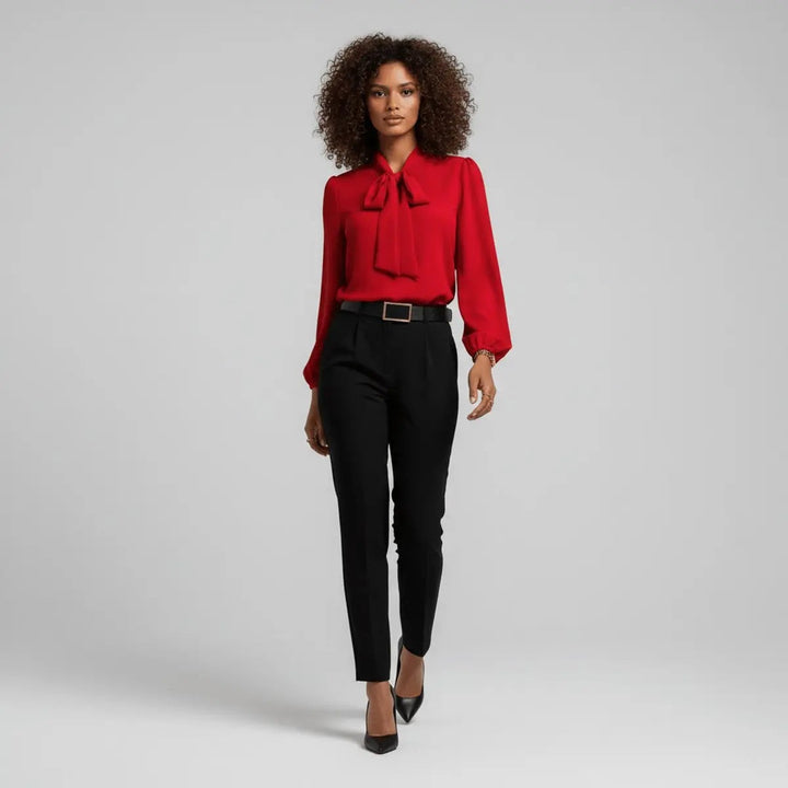 Red bow tie blouse styled with black tailored trousers, full-length view