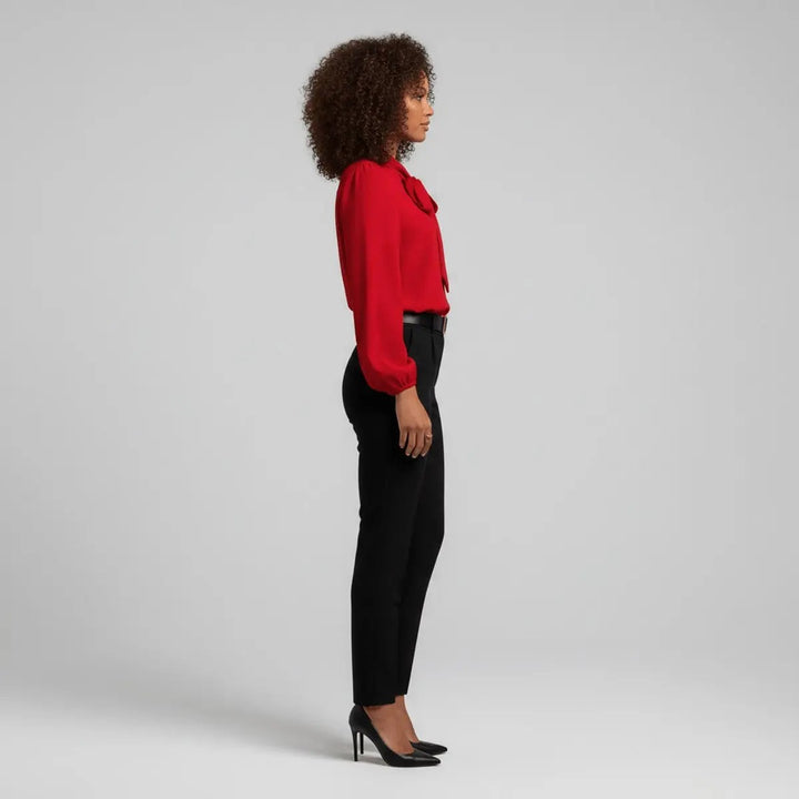 Side profile of red pussy-bow blouse paired with black trousers