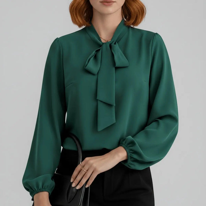 Emerald green bow tie neck blouse with elasticated cuffs, close-up view