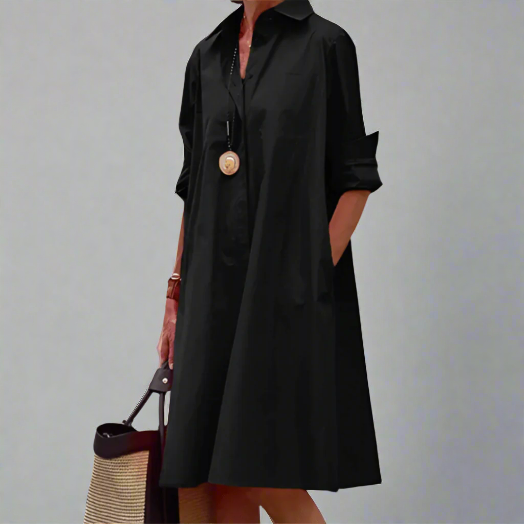 Black collared swing dress featuring rolled cuffs and relaxed fit