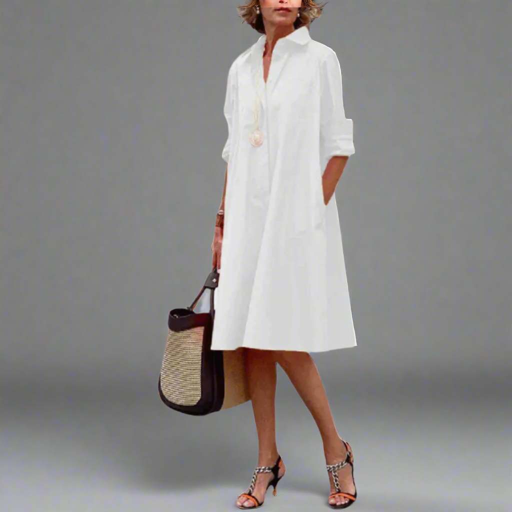 White collared shirt dress styled with strappy sandals and tote bag