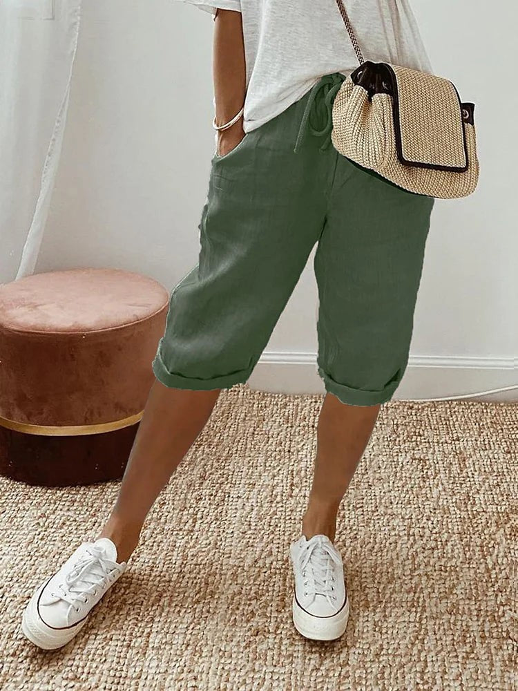 Sage green linen turn-up trousers with drawstring waist and rolled hems