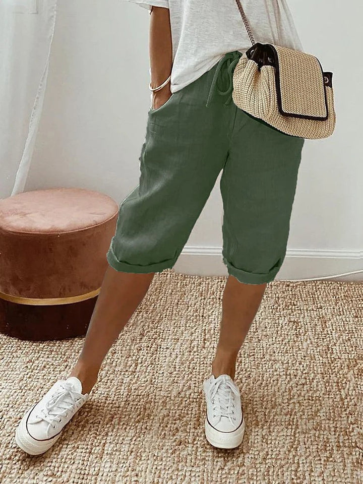 Sage green linen turn-up trousers with drawstring waist and rolled hems