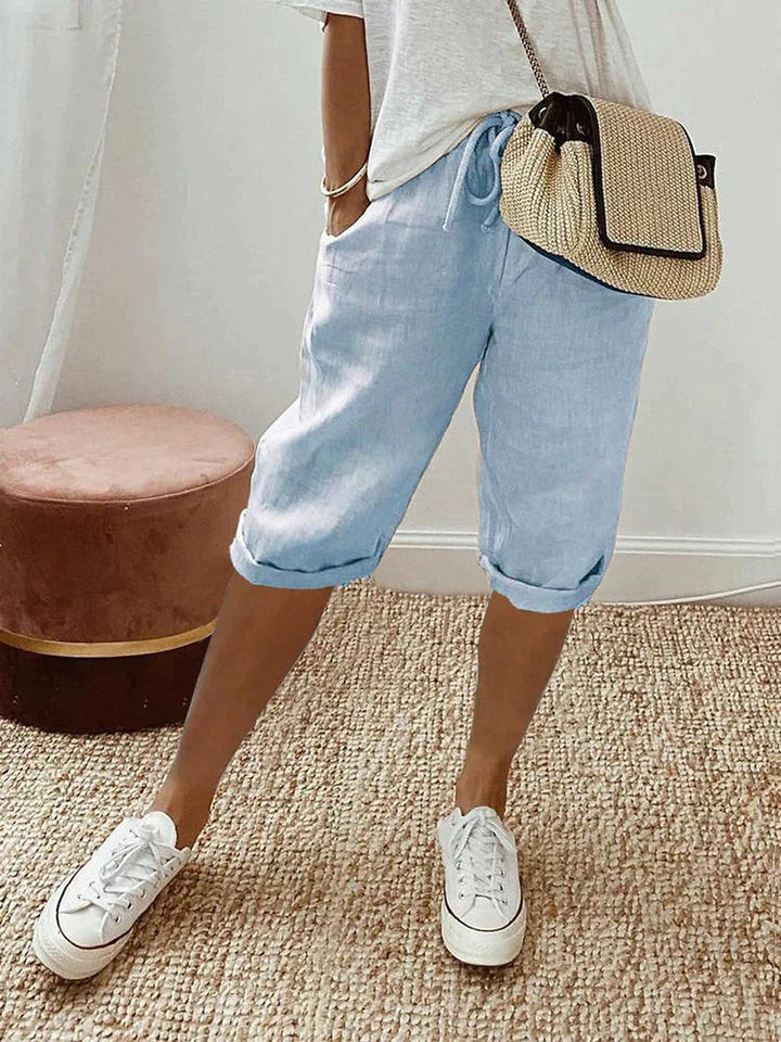 Pale blue linen turn-up trousers with relaxed fit and drawstring waistband