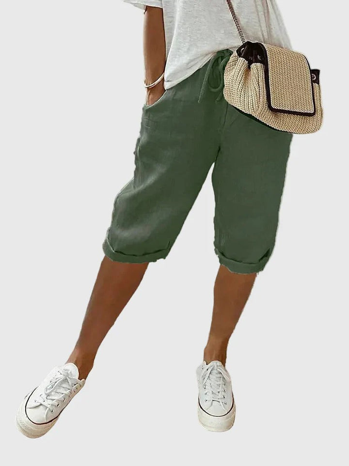 Sage green cropped trousers with turn-up cuffs and casual drawstring waistband