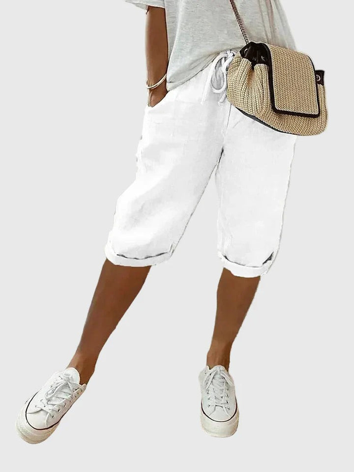 White cropped tailored shorts with turned-up cuffs and drawstring waist detail