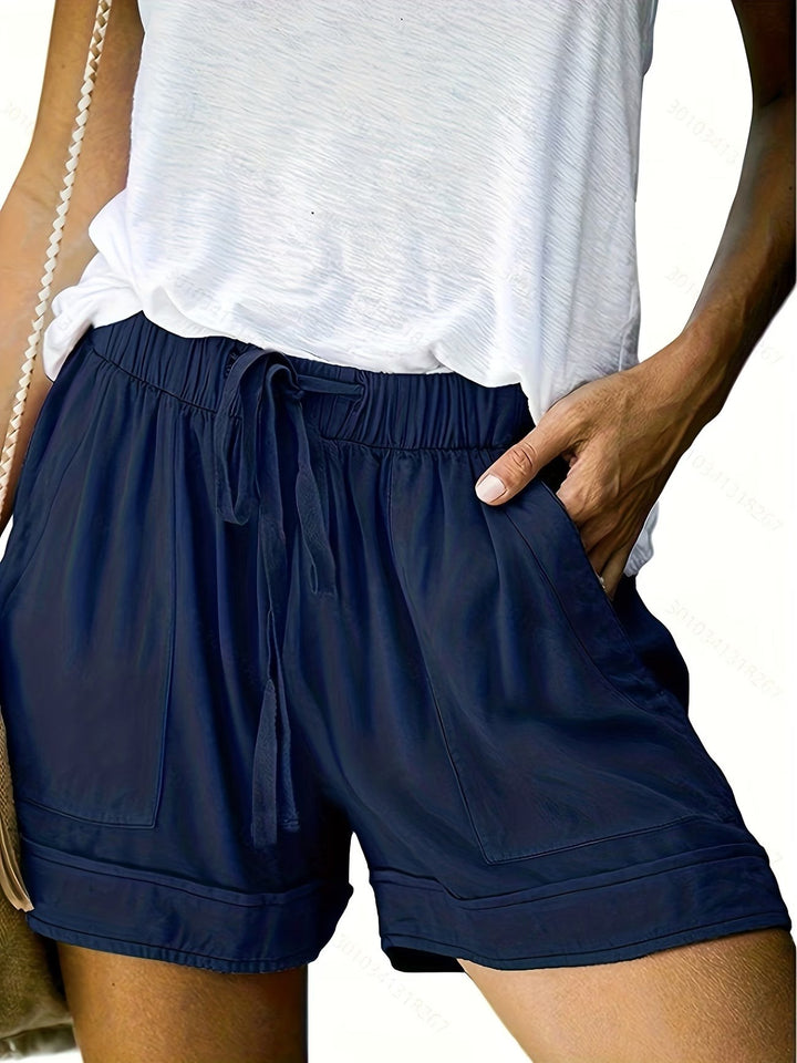 Navy drawstring shorts with elasticated waist, patch pockets and casual white vest