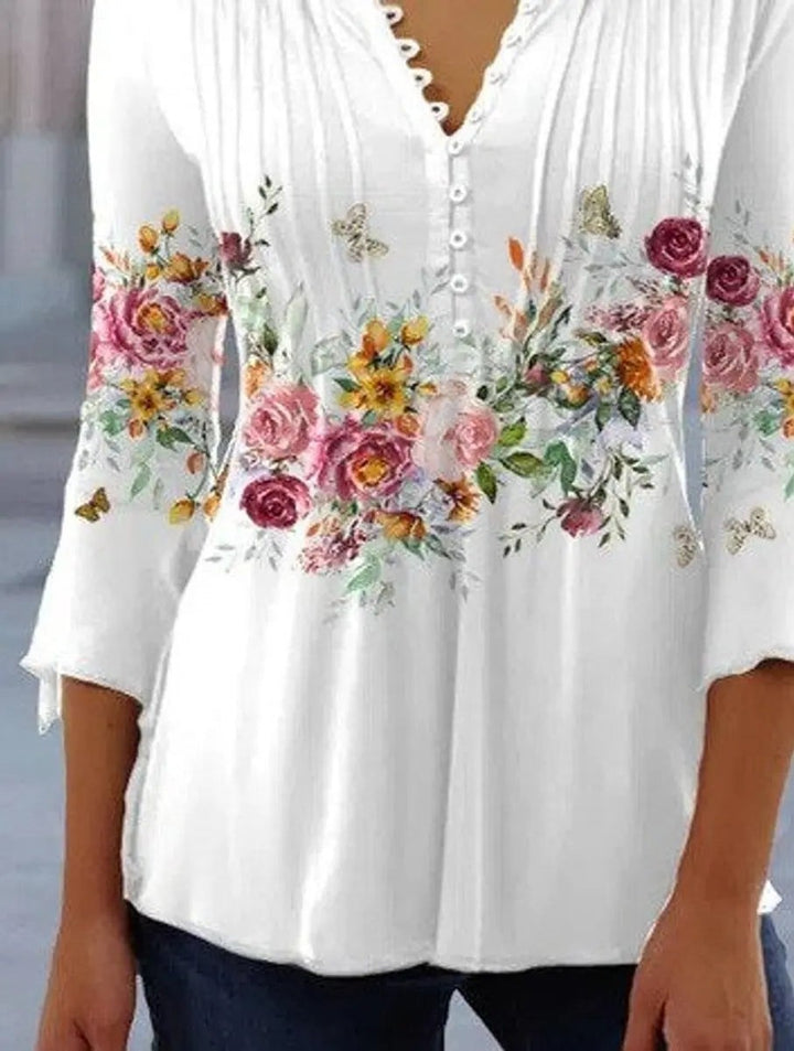 White floral print blouse with scalloped button placket and flared sleeves