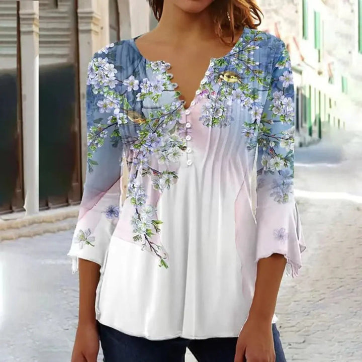 Blue and pink floral henley blouse with bird print and flared cuffs