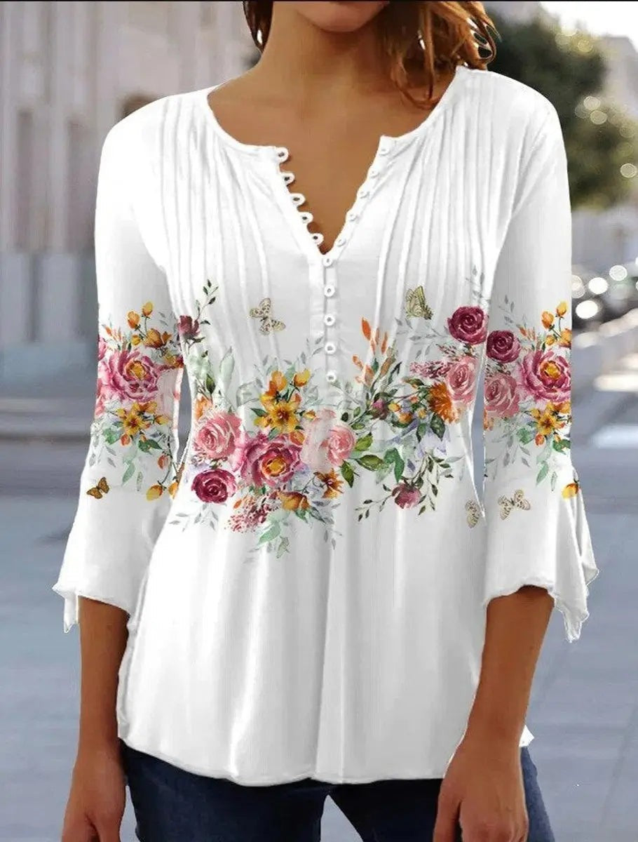 White floral henley blouse with three-quarter flared sleeves and button neckline