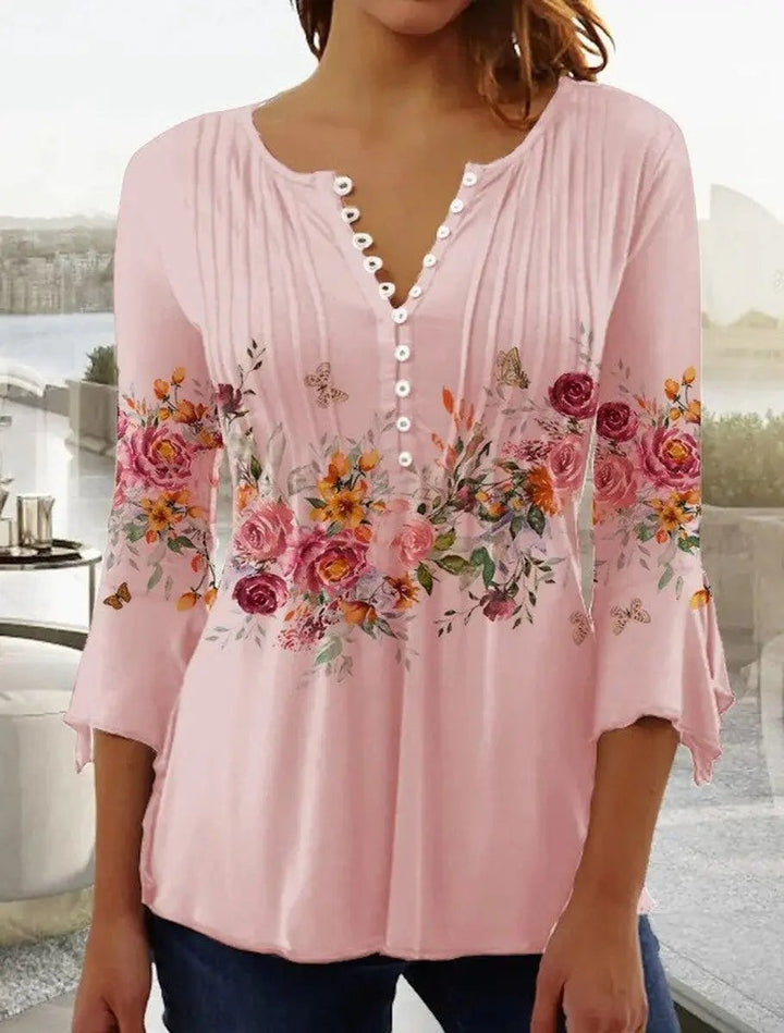 Pink floral henley blouse with scalloped V-neck and bell sleeves