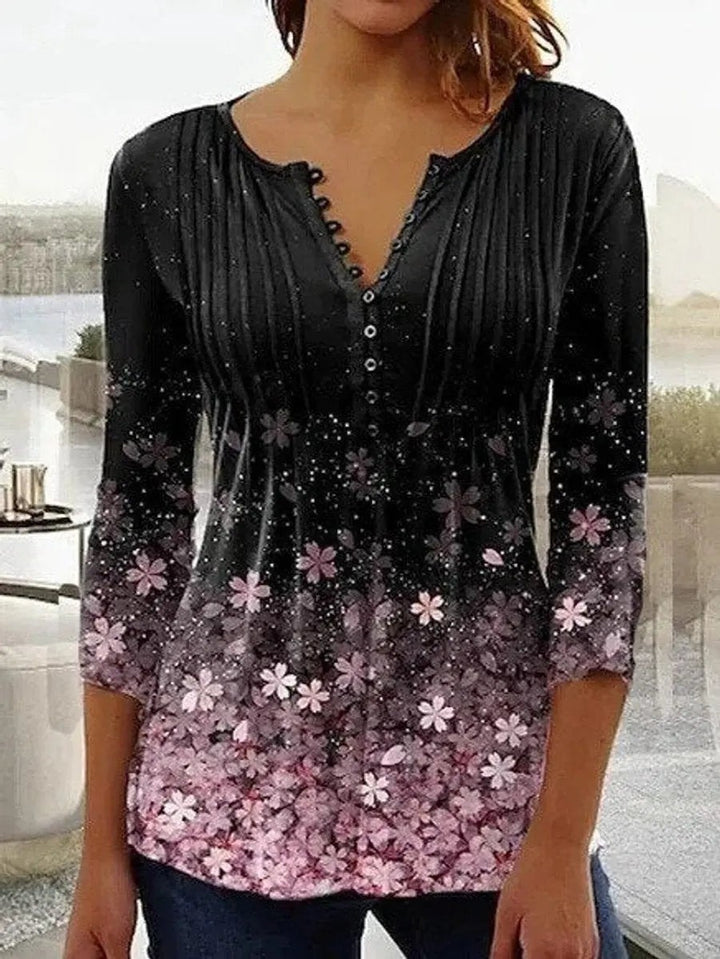 Black henley blouse with ombre pink floral print and flared sleeves