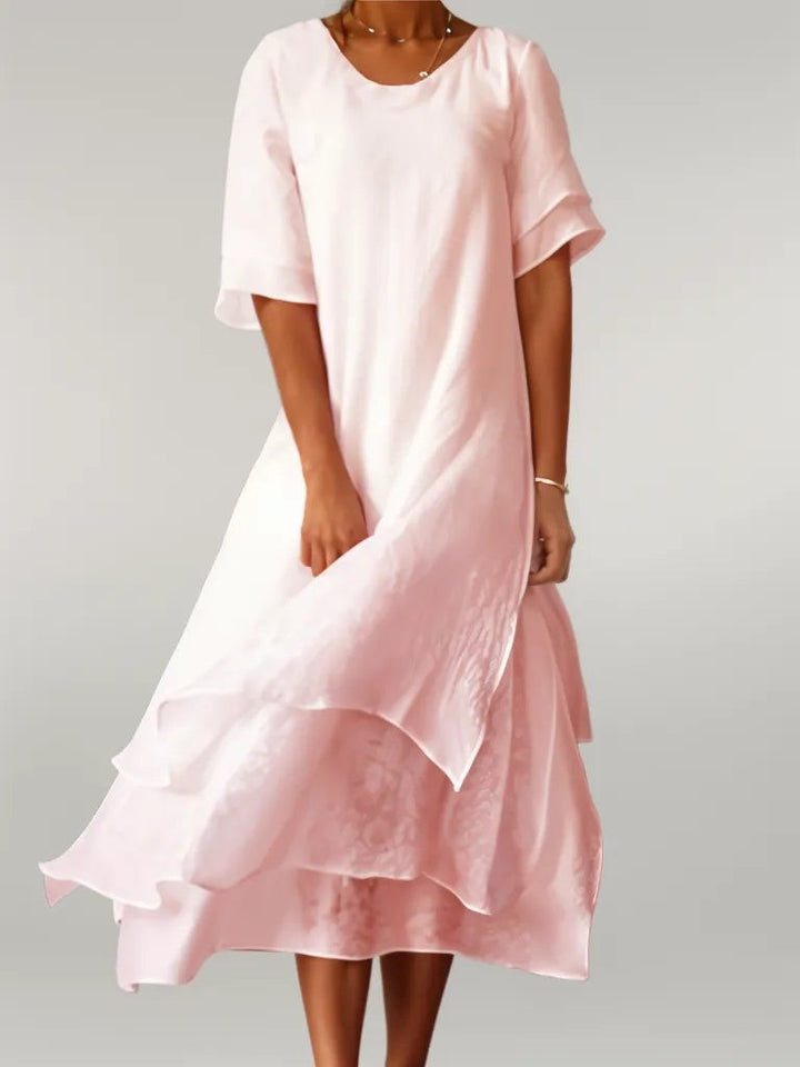 Blush pink layered hem midi dress with flutter sleeves and round neckline